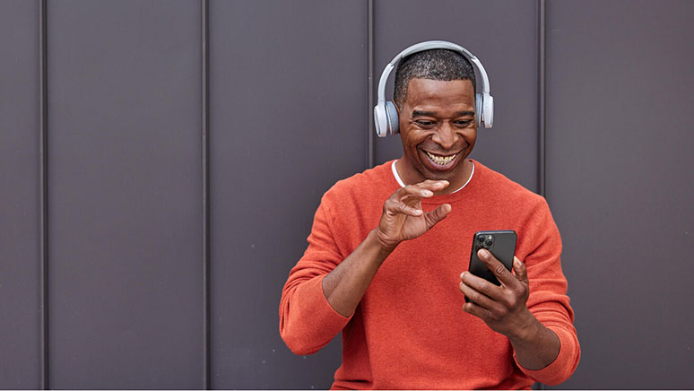 Smiling man touching a mobile phone