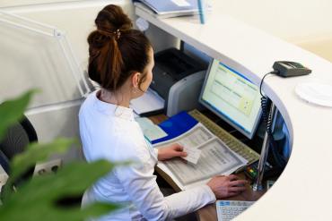 A receptionist working at desk