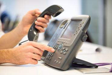 Business person using deskphone