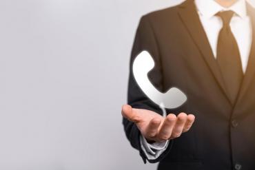 Business person holding phone icon