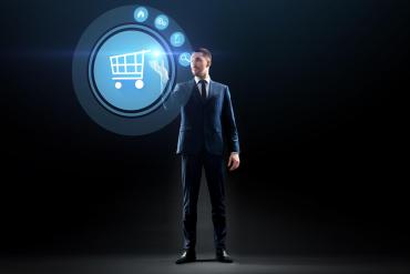 Man standing and selecting an item to buy from a holographic screen