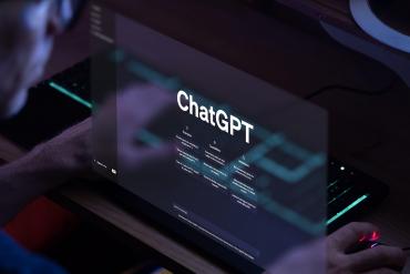 Person looking at screen that reads 'ChatGPT'